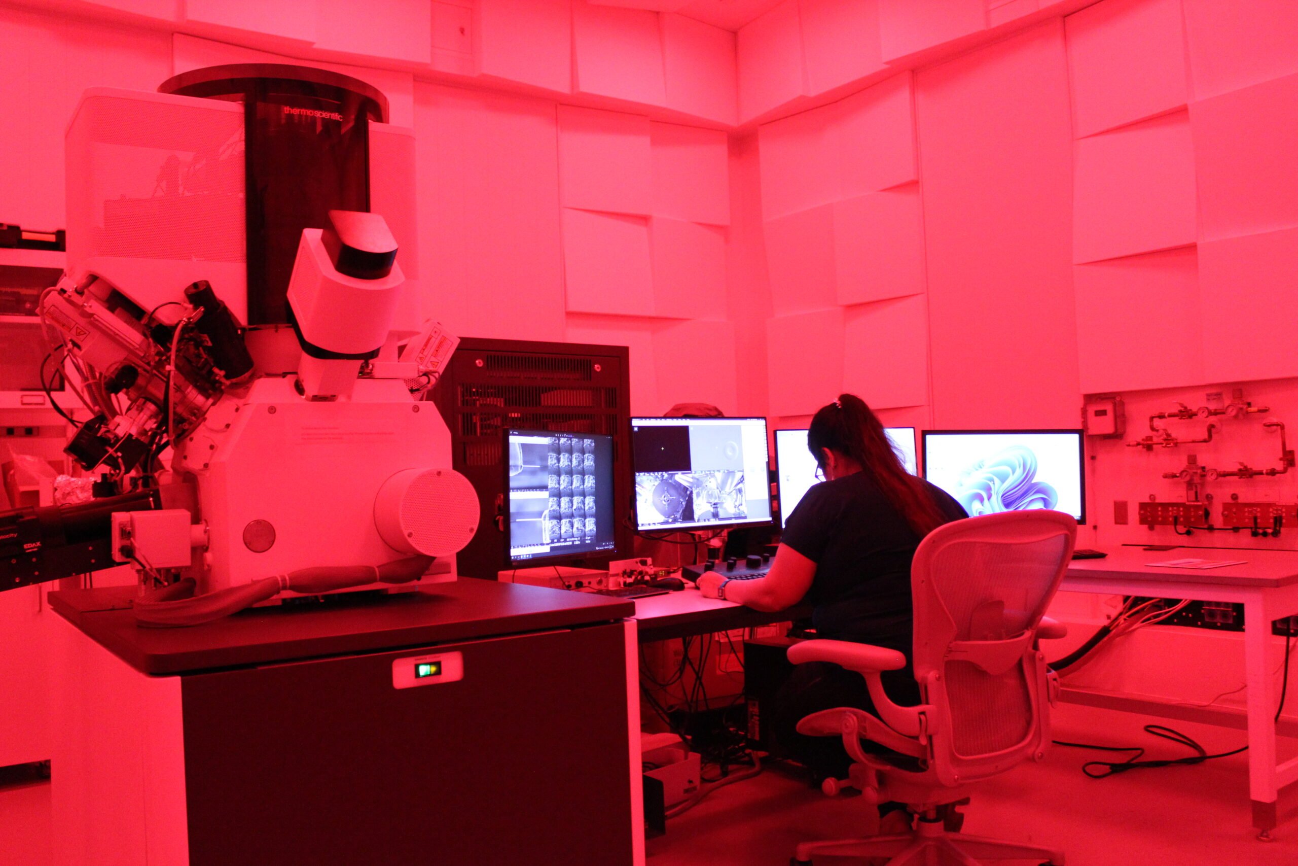 Person at computer in red equipment room