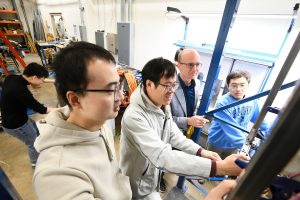 A photo of Thomas Gernay in the lab with his students.