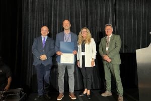 A photo of Shields with the Early Achievement Research Award
