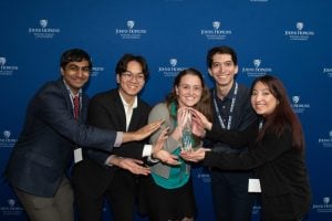 Students showcasing trophy they just won at the competition.