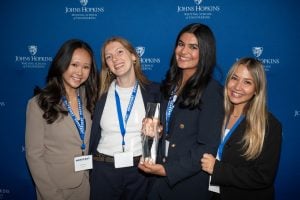 A team of undergraduate students with their first prize trophy at the HopStart awards ceremony
