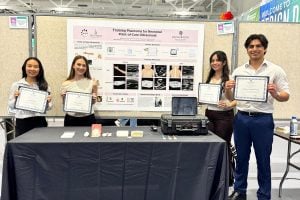 Grace Guan, Allison Booher, Alexa VelezFonseca, and Sebastian Tabares Erices in front of their research poster at Design Day with their Dean's Award certificates