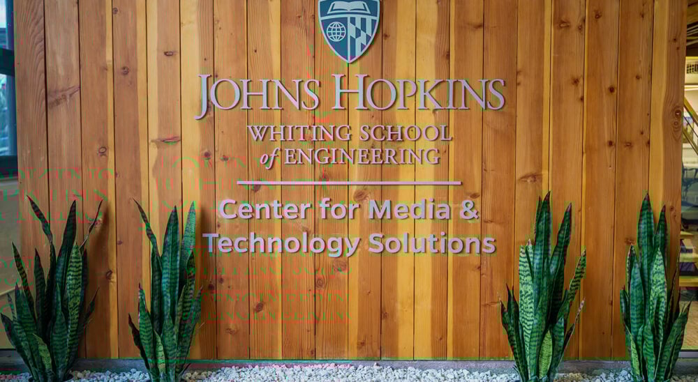 Photo of lobby signage with text Johns Hopkins Whiting School of Engineering Center for Media and Technology Solutions