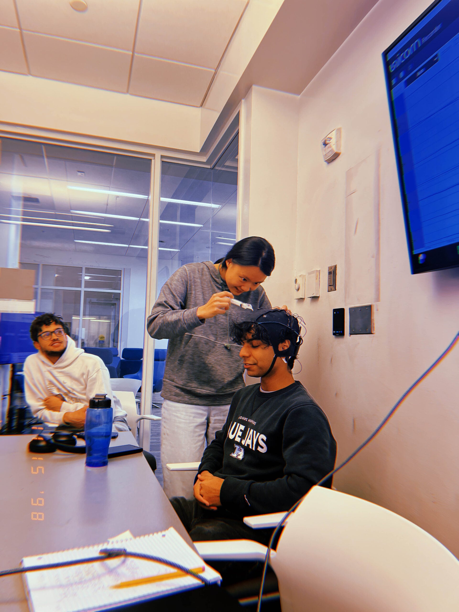 Students setting up EEG headset for data collection