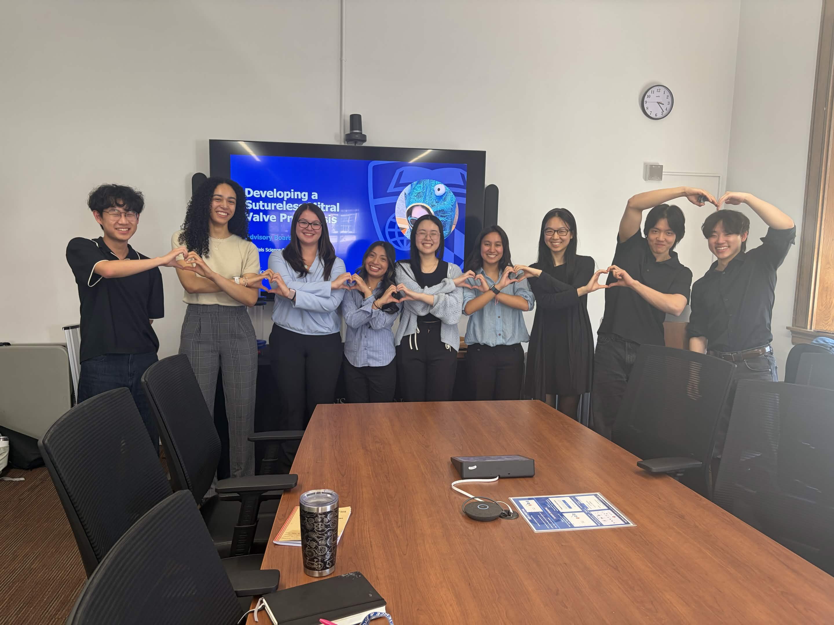 A photo of a team of students at a presentation