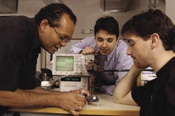 Ralph Etienne-Cummings, associate professor of Electrical and Computer Engineering, guides doctoral students Francesco Tenore (center) and Jacob Vogelstein in the Computational Sensory-Motor Systems Laboratory.