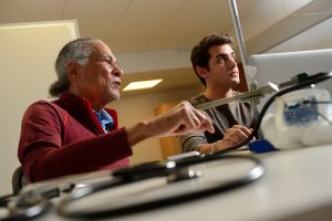 West and graduate student Ian McLane work on the smart stethoscope