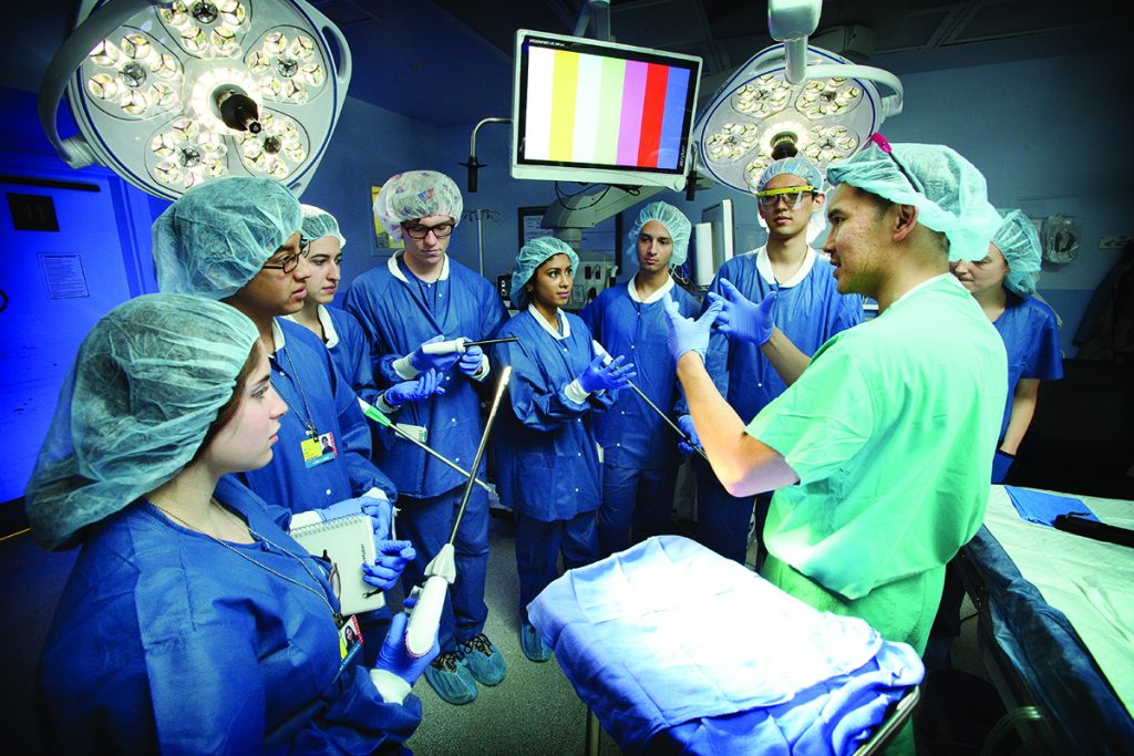 Hien Nguyen, assistant professor of surgery and biomedical engineering, walks through a surgical procedure with a group of undergraduate Design Team leaders in an operating room at Johns Hopkins Bayview Medical Center.