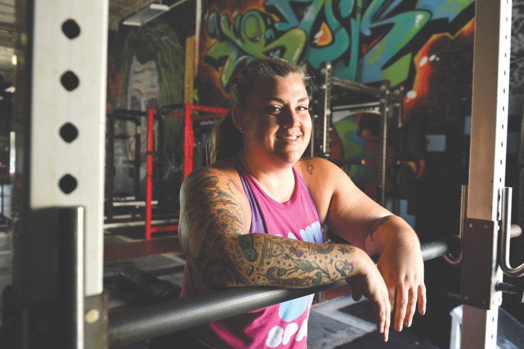 Amy Weldon stands in the gym where she trains for Strongman competitions