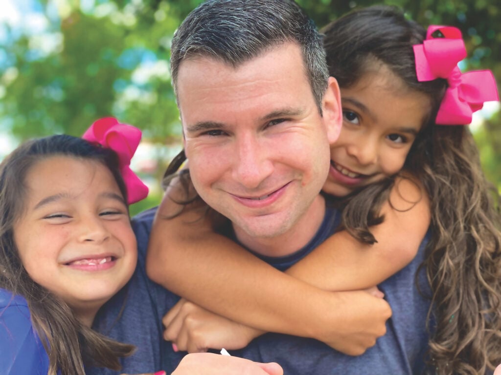 Aaron Baughman with his two daughters