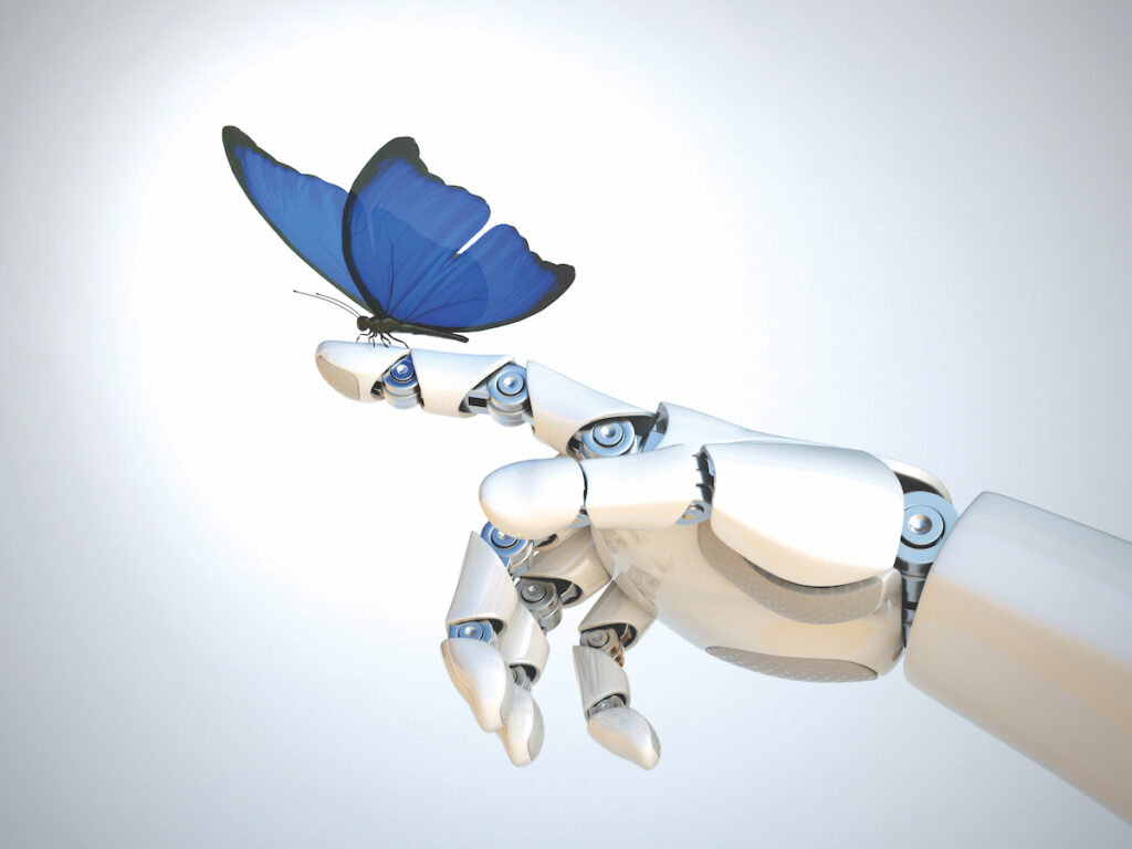 A blue butterfly lands on the outstretched finger of a robotic hand