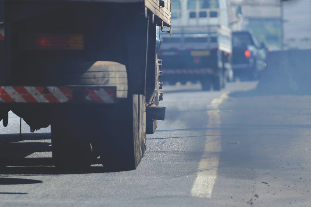 A truck spews exhaust