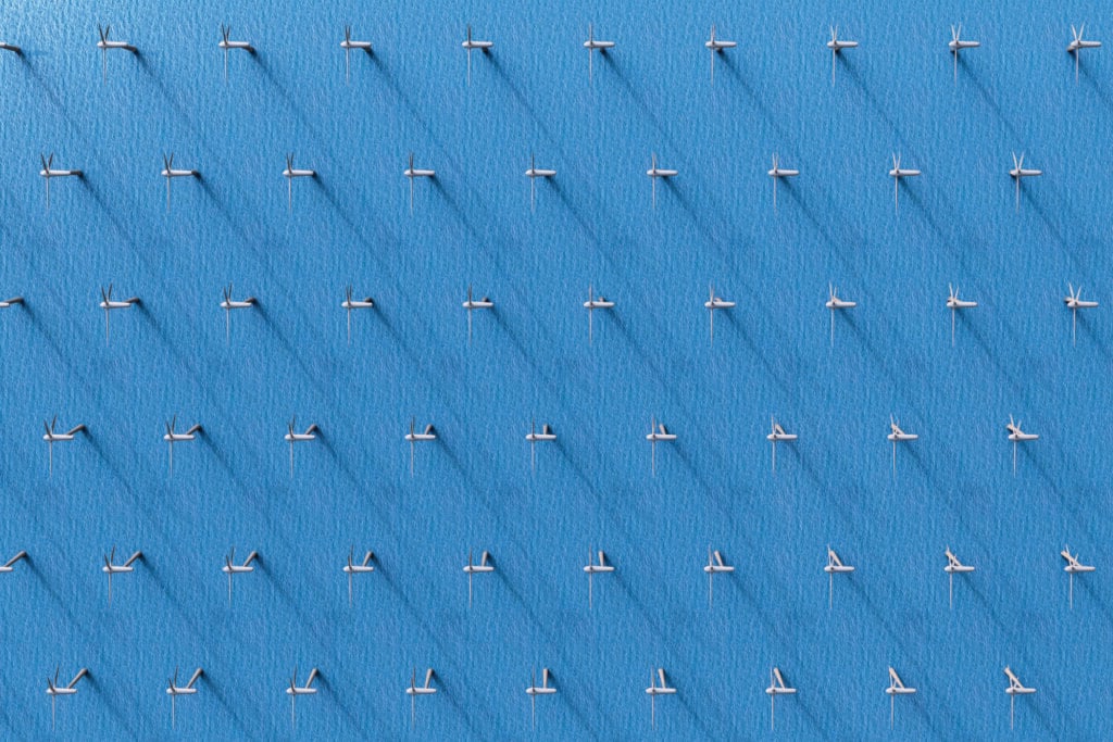 3D rendering of an aerial view of wind turbines in the ocean