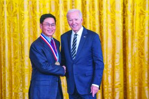 Photo of Jeong Kim shaking hands with President Biden