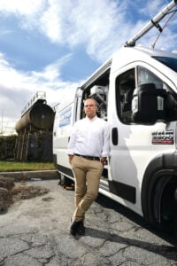 image of Peter DeCarlo standing next to his MOM+POP van