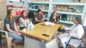 image of a telemedicine team seated around a table having a discussion