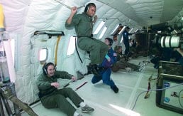 Sara Marten ’04 (seated, for the moment at least) was among the seven Hopkins students who conducted their Team STILLMix experiment during a space flight on NASA’s “Vomit Comet.”