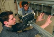 Getting ready to conduct their experiment took months of preparation. Paul Gosling ’03 A&S (left) and Mike Sharma ’04 test their experimental syringes as they prepare for the flight.