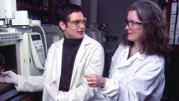 DoGEE Professor A. Lynn Roberts (right) and chemistry major Michael Blumenfeld ’02 use a gas chromatograph/mass spectrometer to measure extremely small amounts of pharmaceuticals in water samples.