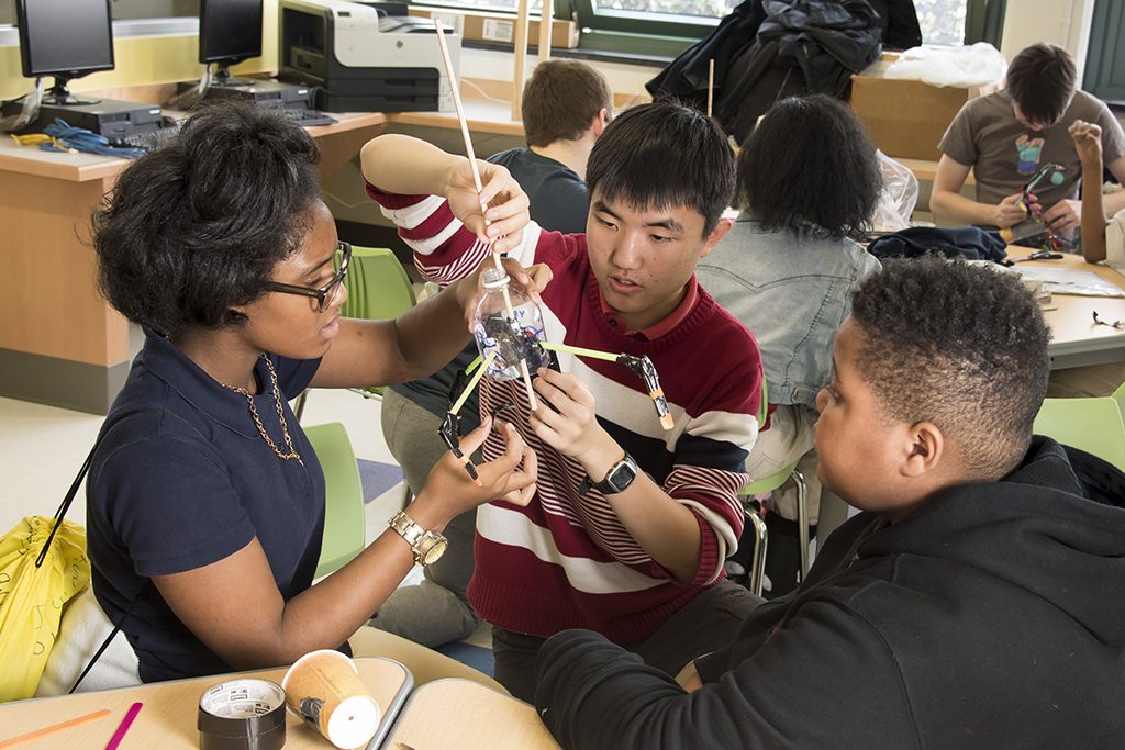 A photo of a JHU student working with Barclay students 