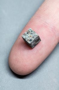 Meteorite sample on a fingertip