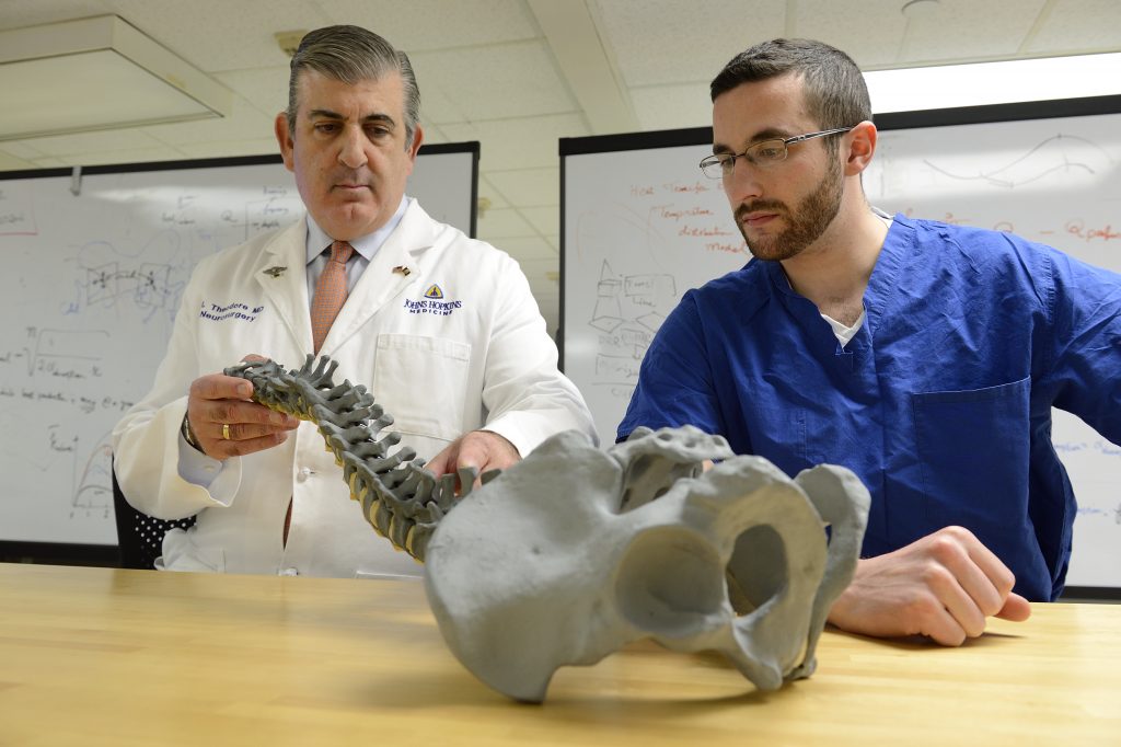 Nicholas Theodore, MD (left), director of the Johns Hopkins Neurosurgical Spine Center, advises David Gullotti.