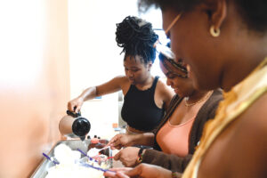 Photograph of students making their own haircare products