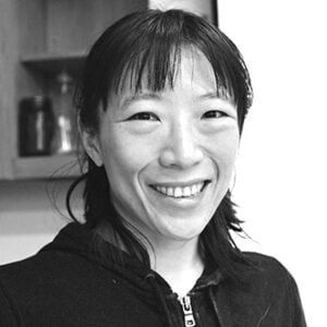 Grey or black and whie photo of Yun Chen smiling.