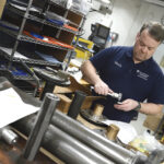 Photograph of Mark Cooper tooling something in the Machine Shop