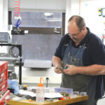 Photograph of Daren Ayers making bioreactors in the Machine Shop