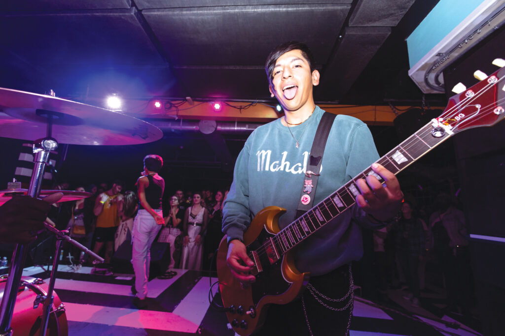 Photograph of Paul Vallejo playing at a concert with his band Pinkshift