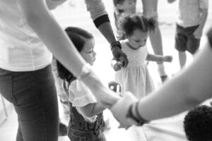 black-and-white image of small children holding hands