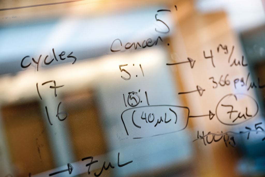 Image of an equation written on a glass wall