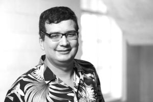 grayscale image of Najim Dehak wearing a Hawaiian shirt