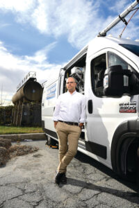 image of Peter DeCarlo standing next to his MOM+POP van