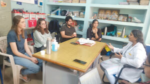 image of a telemedicine team seated around a table having a discussion