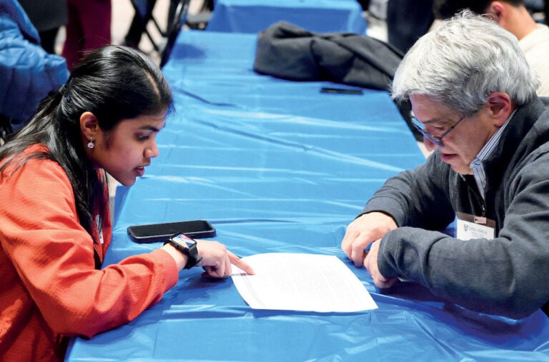 A student and an mentor review a student's resume together