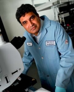 David Gracias at a microscope in his lab.