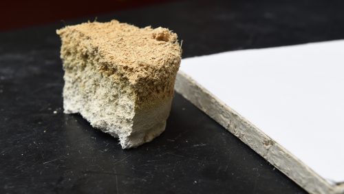 A thick, brown drywall next to a white thin piece.