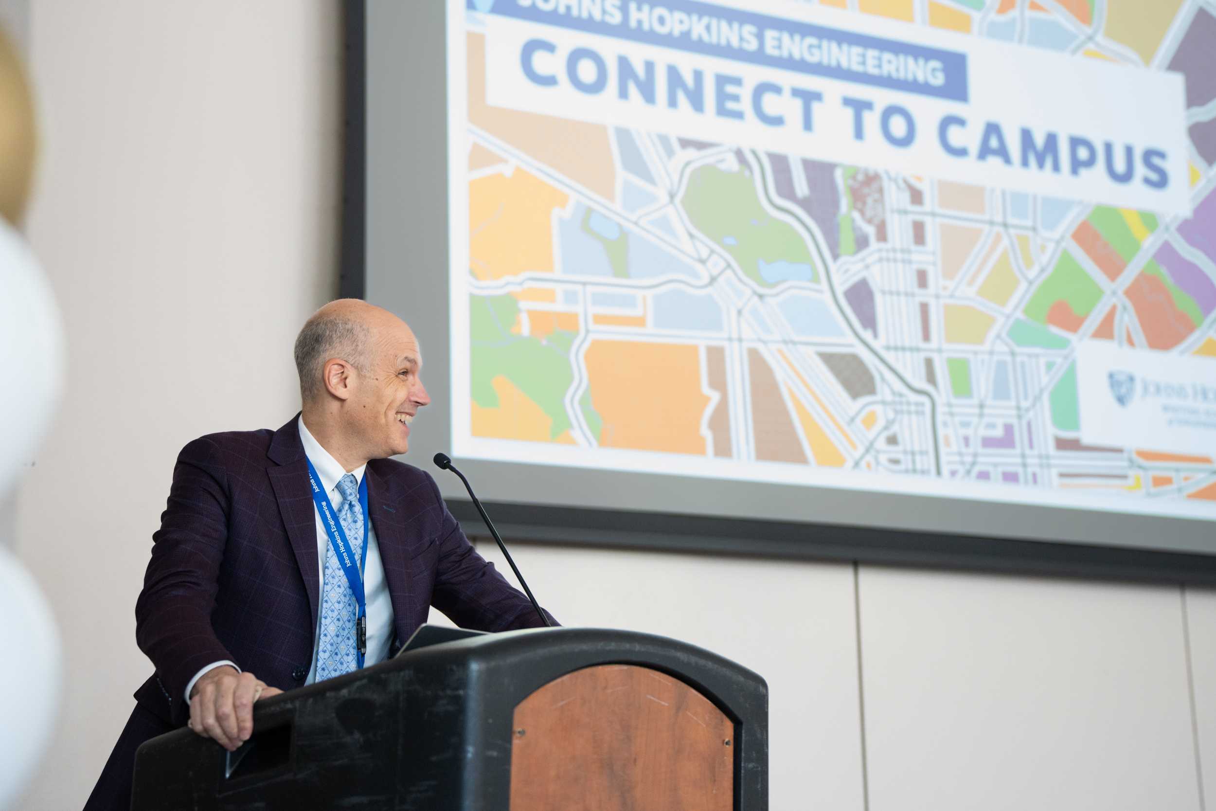 Dr. Dan Horn, Associate Vice Dean for Professional Education and Lifelong Learning standing at a podium and addressing the audience at Connect to Campus event.