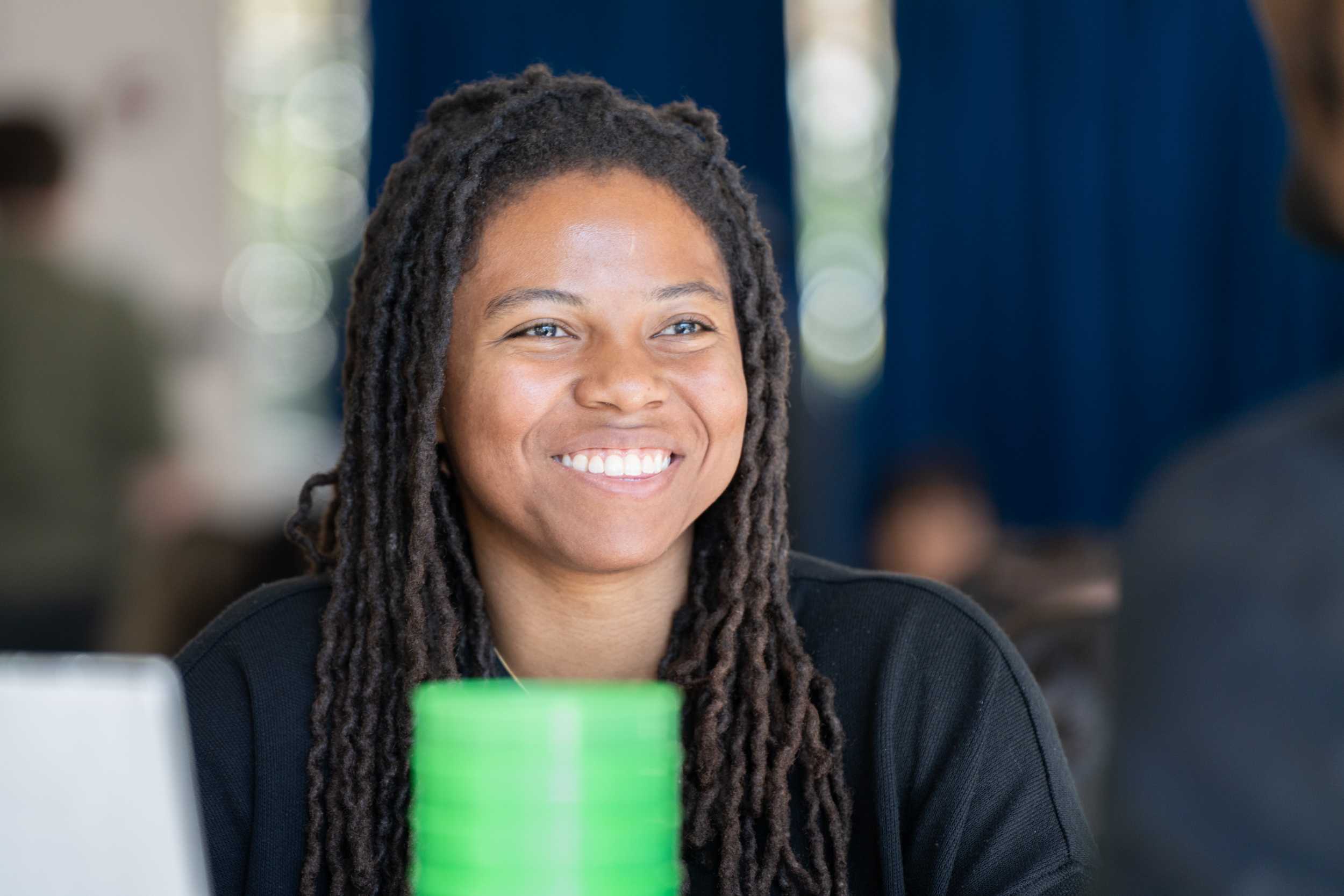 Attendee at Connect to Campus sitting at a table smiling