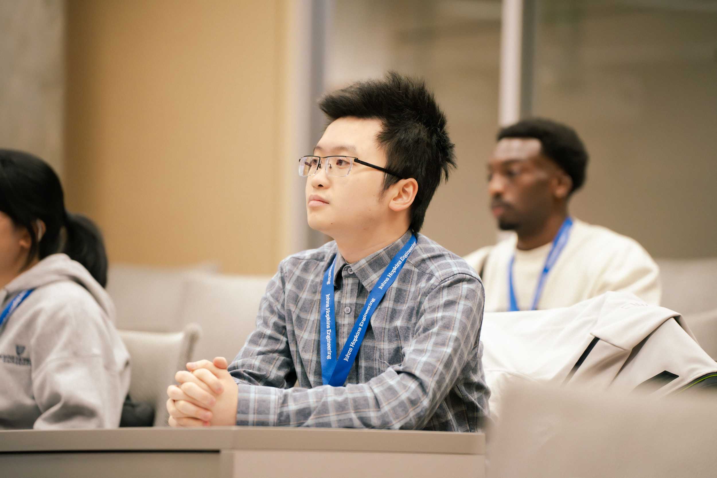 Attendee at Connect to Campus sitting at a table in a conference space