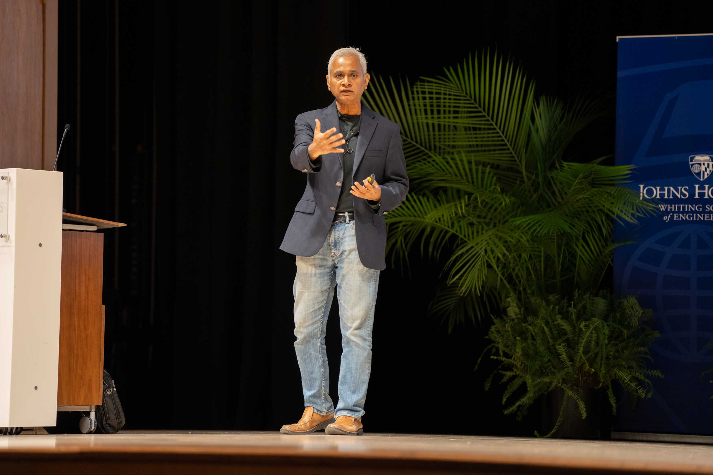 Professor Rama Chellappa speaking on stage at Connect2Campus event.