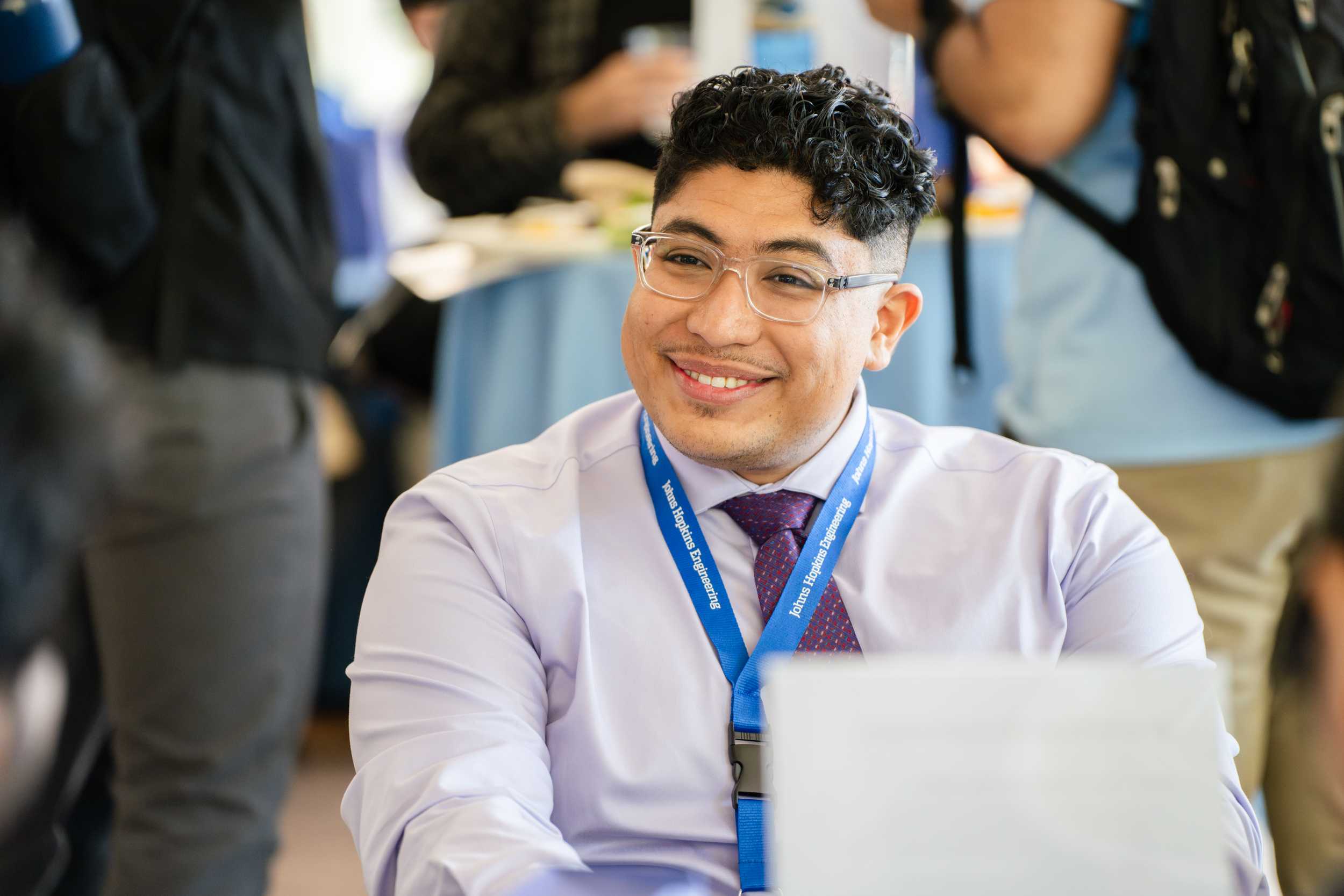 Attendee sitting at a table at Connect2Campus.