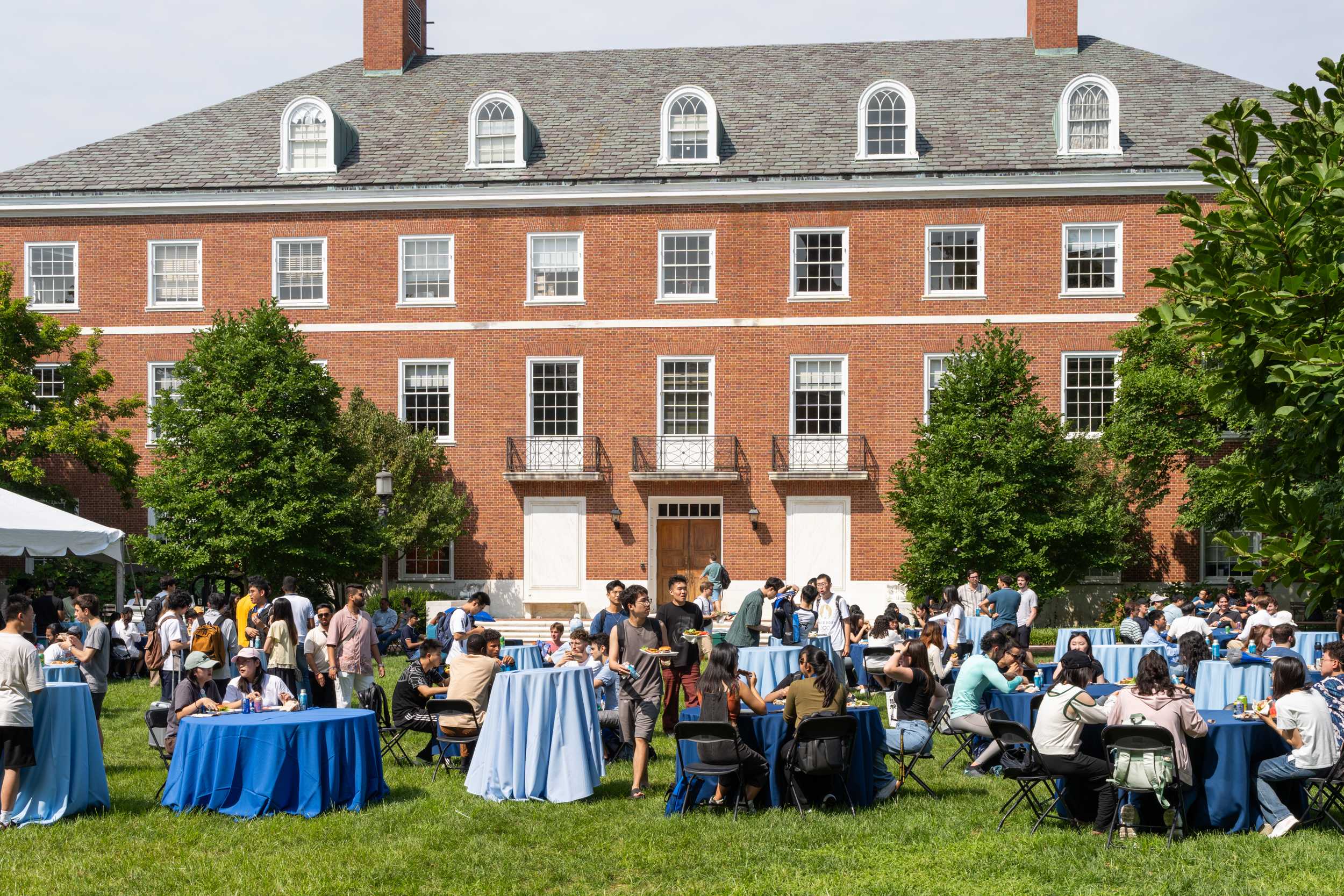 View of campus with tables and participants at the 2024 Graduate Welcome lunch.