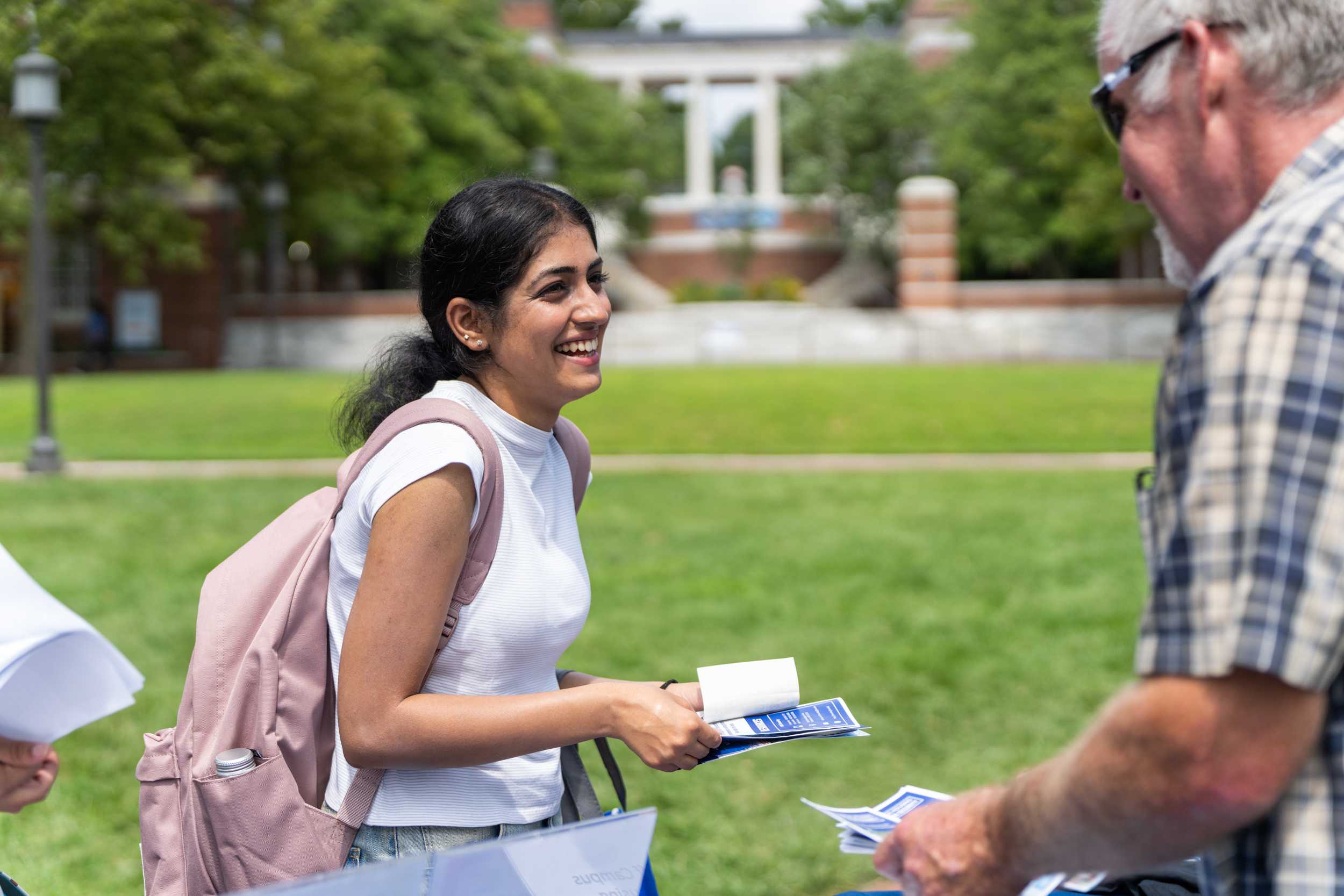 Attendee smiling at the graduate welcome event