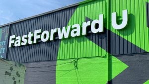 The outer facade of the FastForward U building, painted with the green logo.