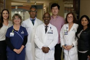 Suchi Saria and her team of doctors posing for a picture
