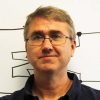 A headshot of David Hovemeyer wearing glasses