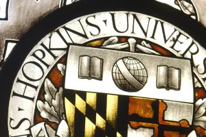Close view of the stained glass of Johns Hopkins University logo.
